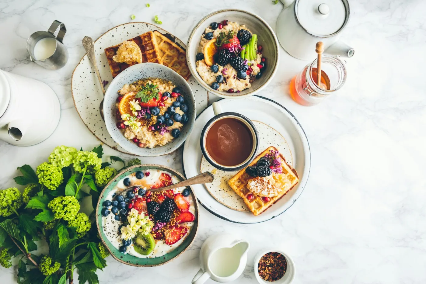 A brunch table set with bowls, waffles and coffee